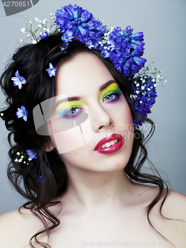 Image of Beauty young woman with flowers and make up close up, real sprin