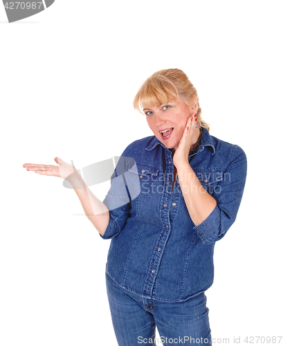 Image of Smiling blond woman pointing.