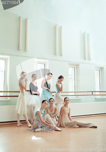 Image of The seven ballerinas at ballet bar