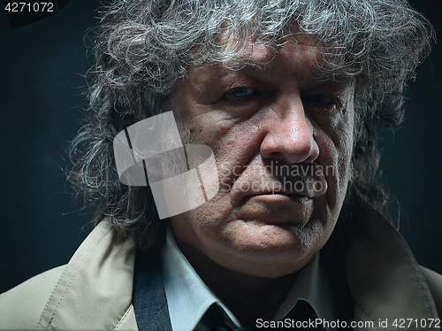 Image of The senior man as detective or boss of mafia on gray studio background