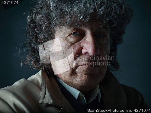 Image of The senior man as detective or boss of mafia on gray studio background