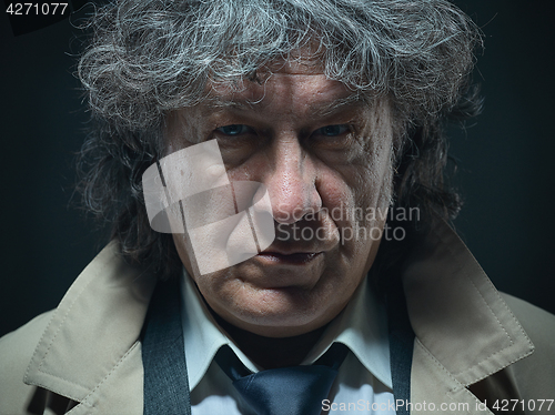 Image of The senior man as detective or boss of mafia on gray studio background