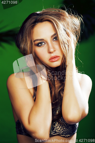 Image of young cute blonde woman on green palm background smiling happy, lifestyle peole concept 