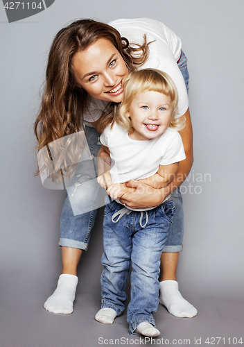 Image of young pretty stylish mother with little cute blond daughter hugging, happy smiling real family, lifestyle people concept