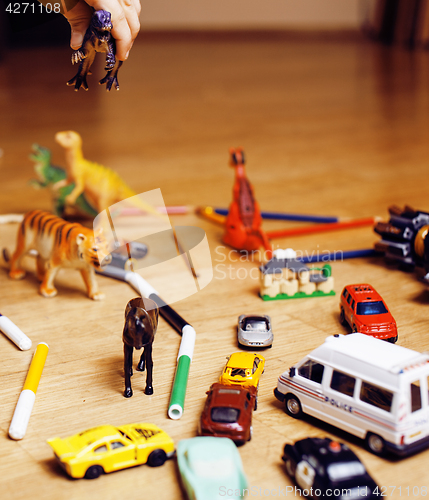 Image of children playing toys on floor at home, little hand in mess, free education