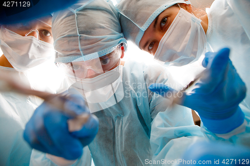 Image of Surgeons holding instruments in hands