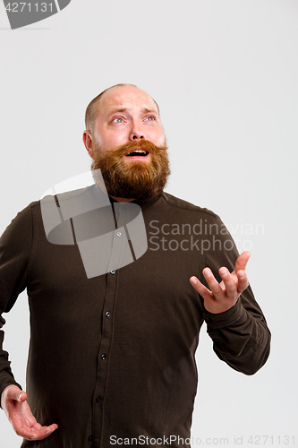 Image of Man in shirt looks up