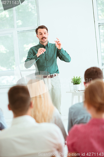 Image of Speaker at Business Meeting in the conference hall.