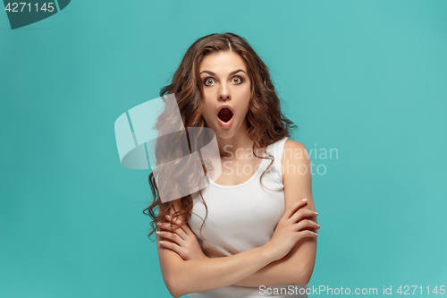 Image of Portrait of young woman with shocked facial expression