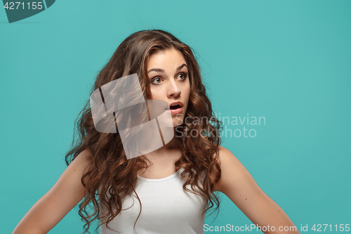 Image of Portrait of young woman with shocked facial expression