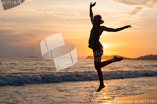 Image of Happy girl jumping on the beach