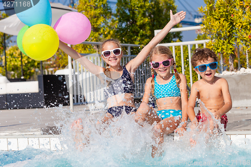 Image of happy children  playing on the swimming pool at the day time.