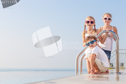 Image of happy children  playing on the swimming pool at the day time.