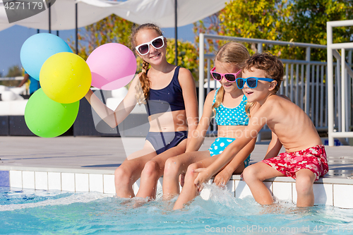 Image of happy children  playing on the swimming pool at the day time.