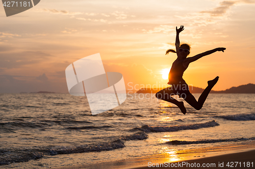 Image of Happy girl jumping on the beach