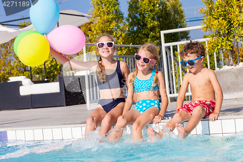 Image of happy children  playing on the swimming pool at the day time.