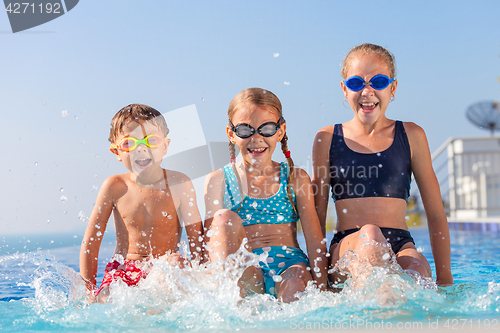 Image of happy children  playing on the swimming pool at the day time.