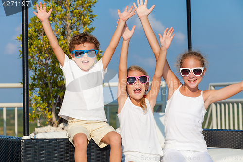 Image of happy children  playing on the swimming pool at the day time.