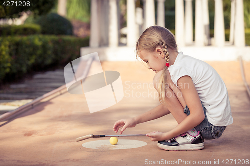 Image of Little girl swinging golf club