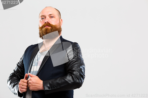 Image of Man with beard clings jacket
