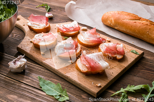 Image of Wooden cutting board with sandwiches