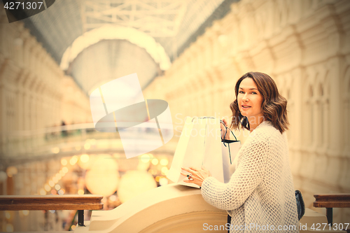 Image of woman with packages in a shopping center