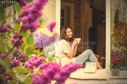 Image of beautiful woman with a cup of hot drink