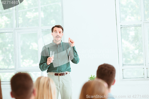 Image of Speaker at Business Meeting in the conference hall.