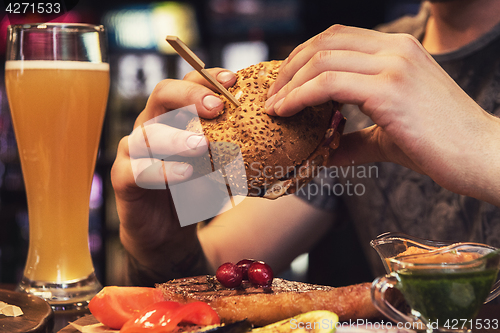 Image of Man eating burgers