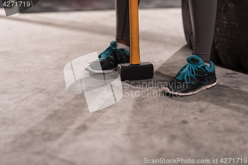 Image of black woman after workout with hammer with focus on legs