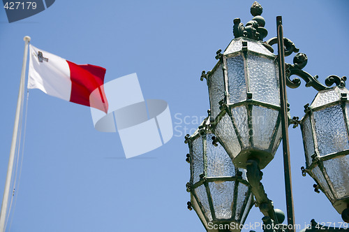 Image of flag malta with historic street lamp valletta