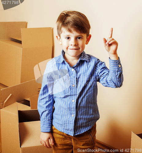 Image of little cute boy in empty room, remoove to new house. home alone 