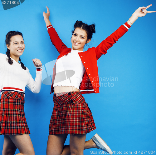 Image of best friends teenage school girls together having fun, posing emotional on blue background, besties happy smiling, lifestyle people concept 