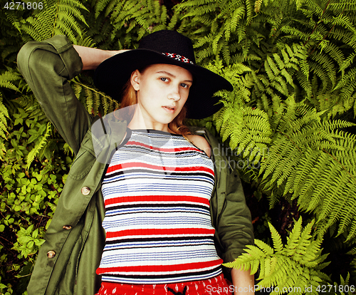 Image of Pretty young blond girl hipster in hat among fern, vacation in green forest, lifestyle fashion people concept