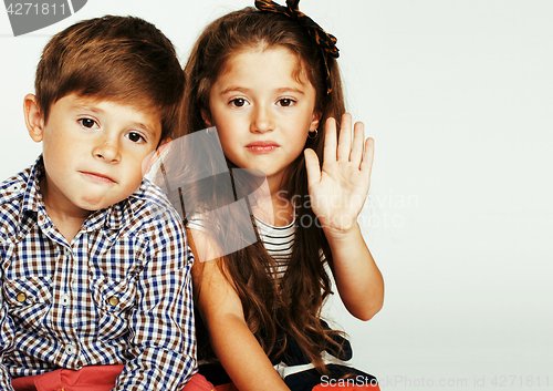 Image of little cute boy and girl hugging playing on white background, ha