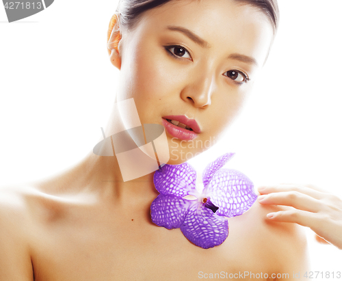Image of young pretty asian woman with flower purple orchid close up isol