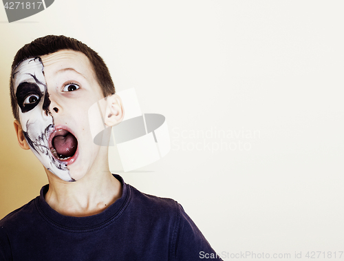 Image of little cute boy with facepaint like skeleton to celebrate hallow