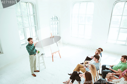 Image of Speaker at Business Meeting in the conference hall.