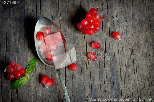 Image of Ripe pomegranate and spoon 