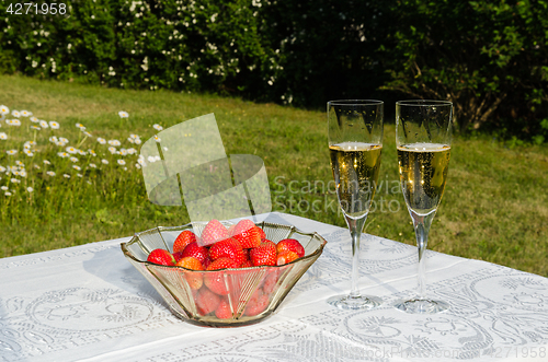 Image of Bowl with strawberries and two glasses with champagne