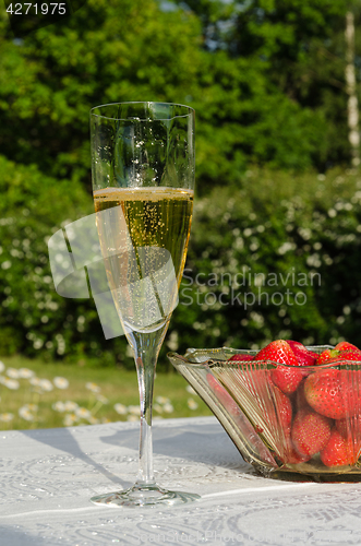 Image of Glass of bubble and strawberries