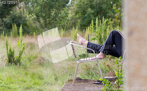 Image of Feet of a woman relaxing in her yard, Iceland