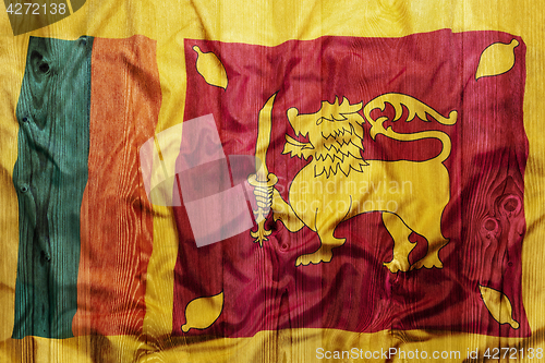 Image of National flag of Sri Lanka, wooden background