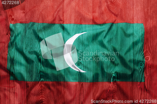 Image of National flag of Maldives, wooden background