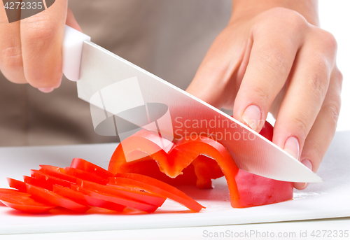 Image of Cook is chopping bell pepper