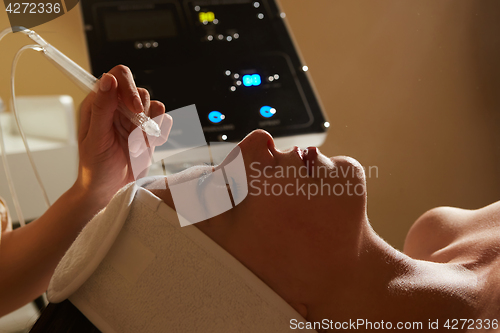 Image of Face Beauty Treatment. Closeup Of Beautiful Woman Getting Facial Gas-liquid Oxygen Water Epidermal Peeling Using Professional Equipment At Cosmetology Center. Skin Care Concept.