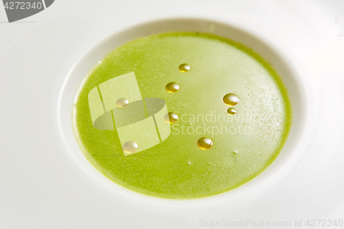 Image of cream soup puree of green peas view from the top