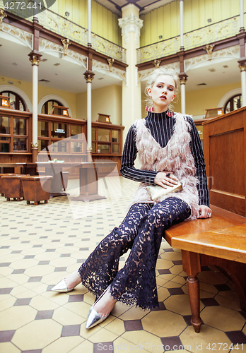 Image of young attractive fashion lady on railway station waiting, vintag