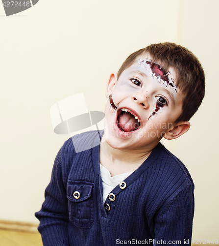 Image of little cute boy with facepaint like skeleton to celebrate hallow