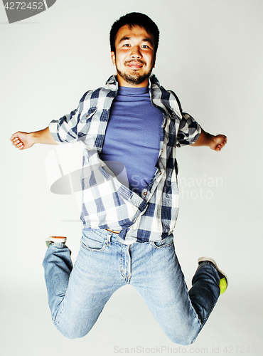 Image of young pretty asian man jumping cheerful against white background